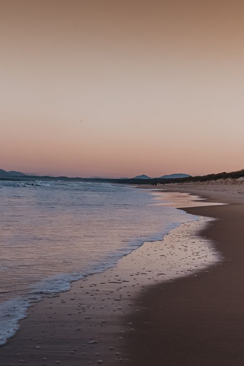Free Peaceful evening at a sandy beach in Santa Catarina, Brazil, captured at sunset. Stock Photo