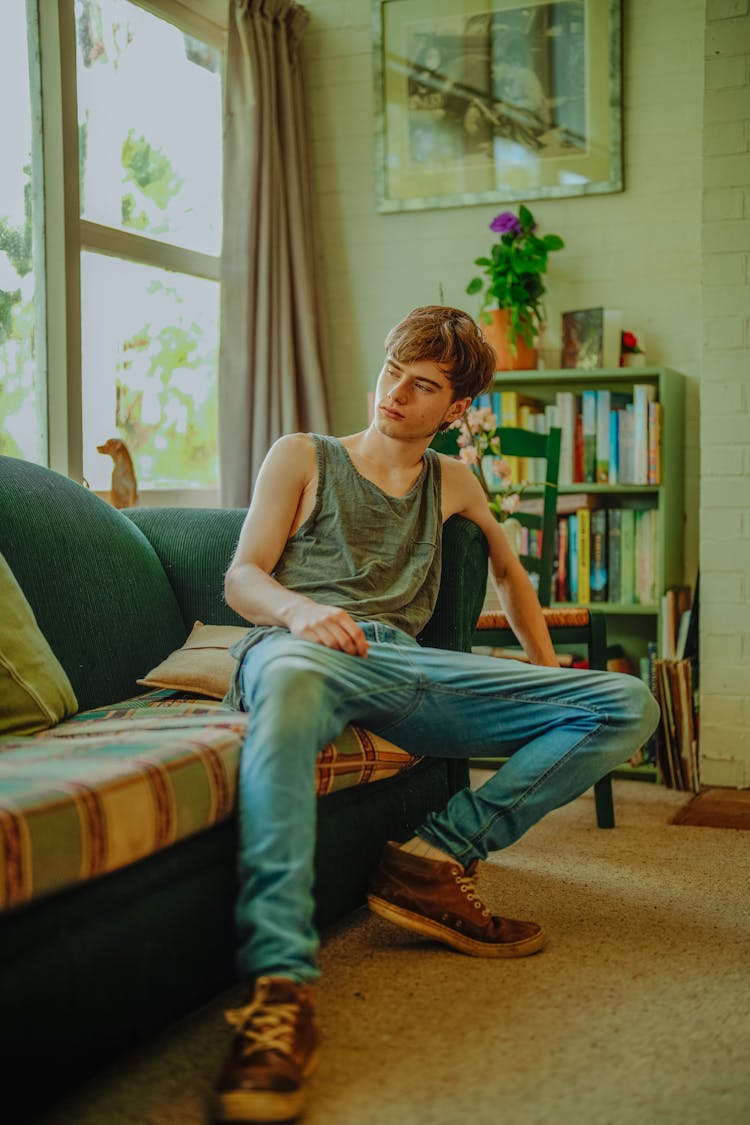 A Young Man Sitting On The Sofa