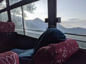 A Person in Blue Hoodie Relaxing Inside a Transport Vehicle