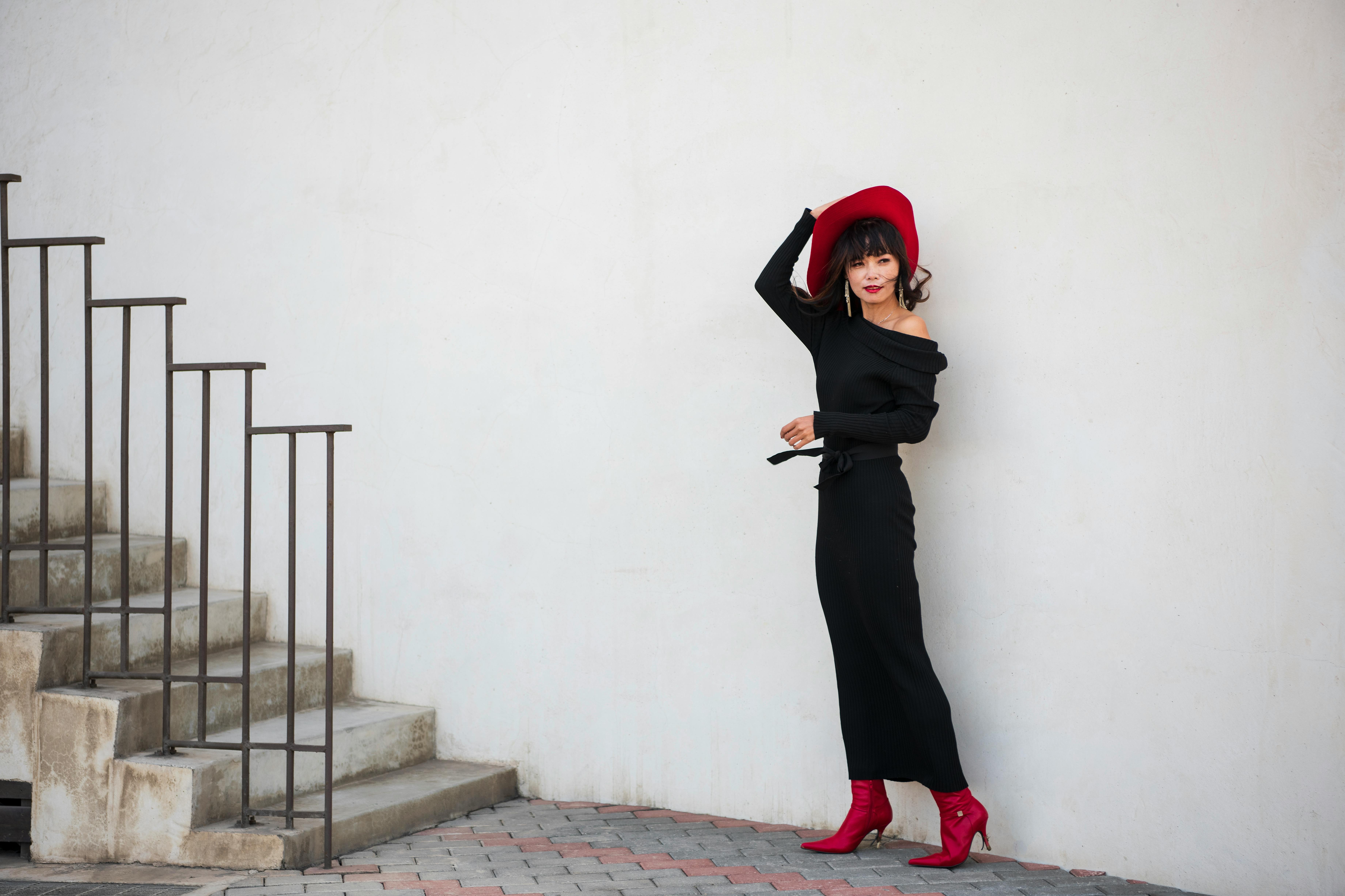 A Woman in a Black Dress Wearing a Hat  Free Stock Photo