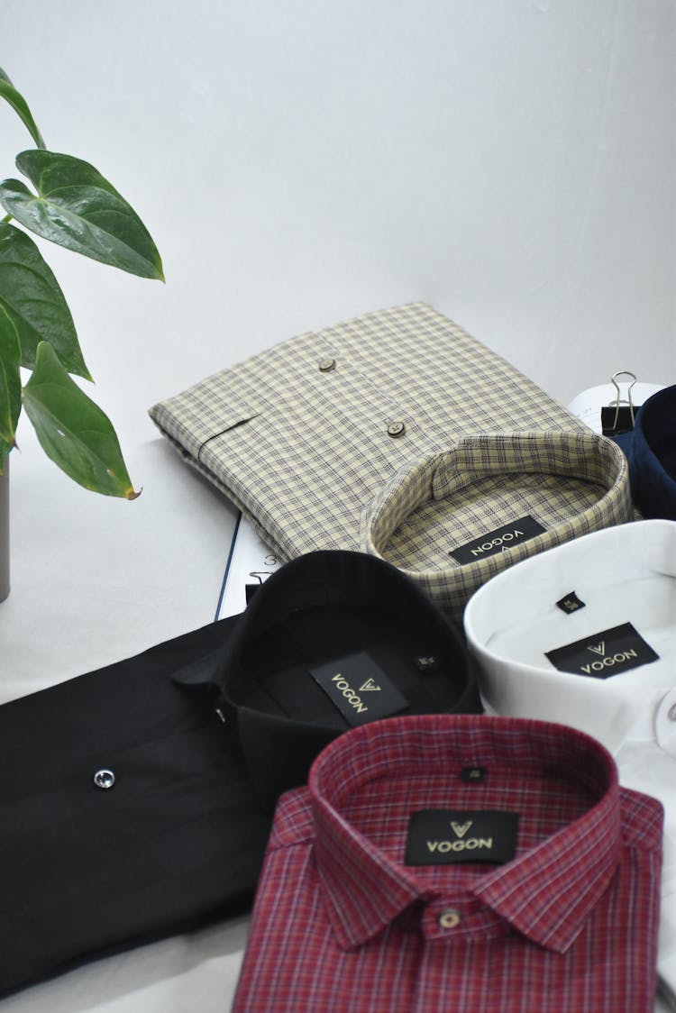 Assorted Folded Polo Shirts Displayed On Table