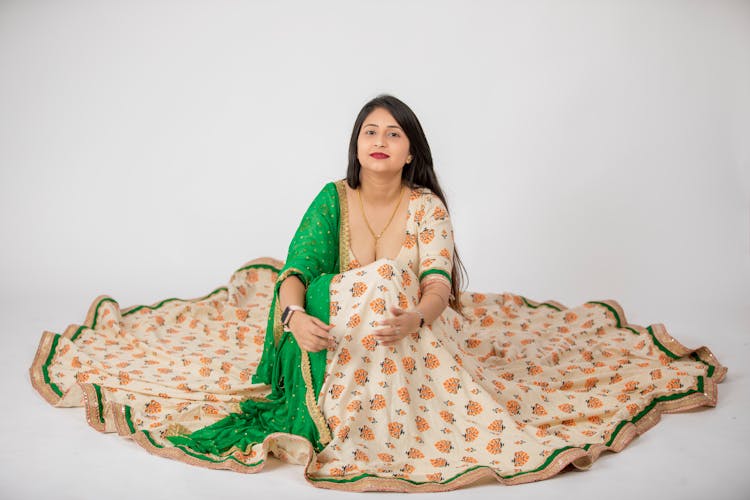 Woman In Traditional Indian Dress Sitting On The Floor 