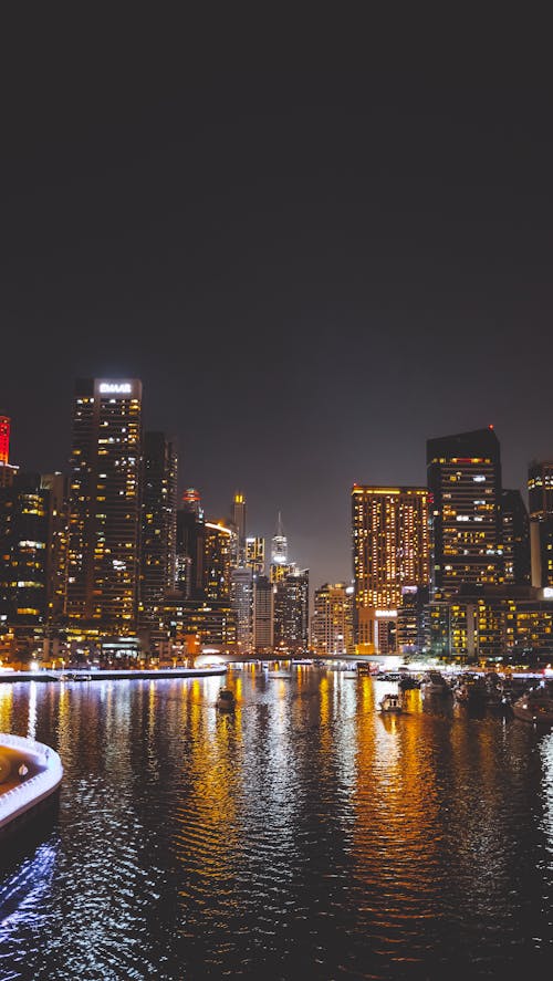 A City Buildings at Night Near the Body of Water