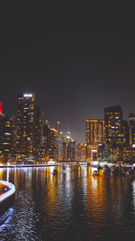 Stunning view of Dubai Marina's illuminated skyscrapers reflecting in the water at night.