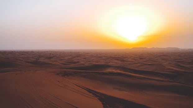 Stunning golden sunset view over the vast sand dunes of Dubai desert.