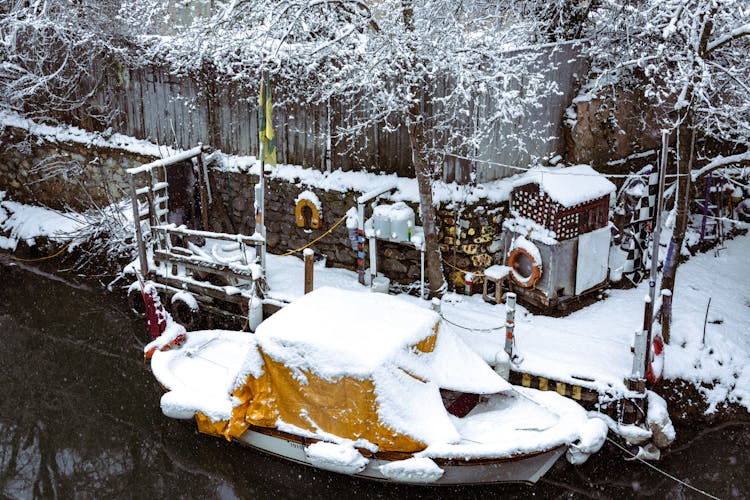 Docked Boat Covered In Snow