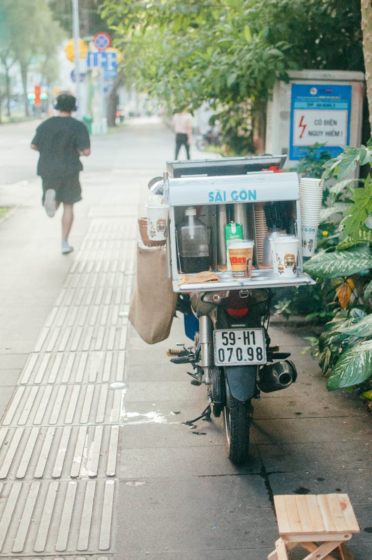 Motorcycle And Man Running On Sidewalk