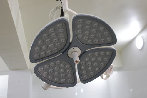 Free Close-up of a modern LED surgical lamp in a well-lit hospital room. Stock Photo