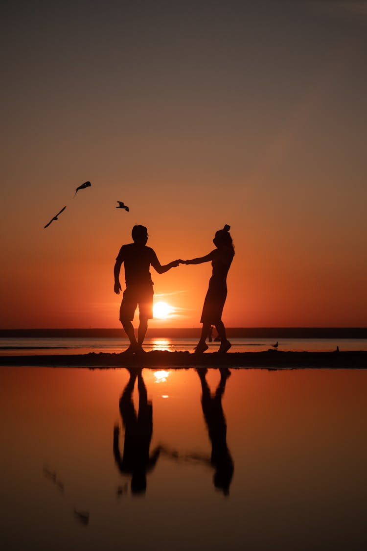 Couple Standing Together On The Beach