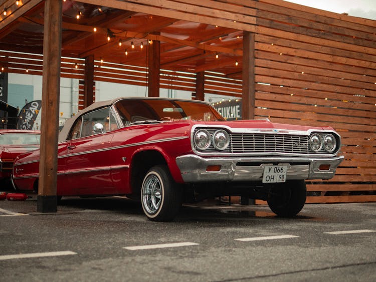 Red Vintage Car Parked In A Wooden Garage