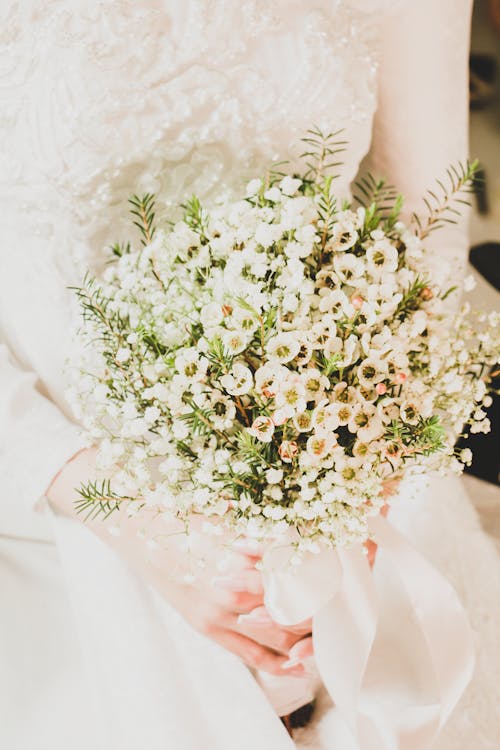 A Bride Holding a Bouquet of White Flowers