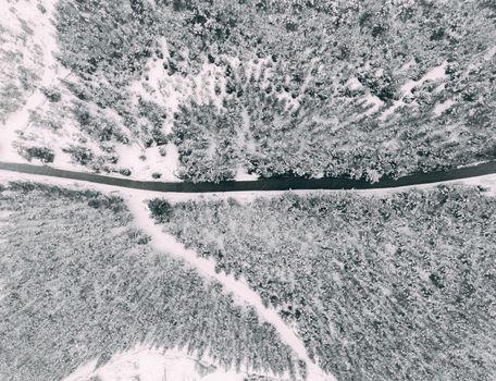 A captivating aerial shot of a snowy forest landscape in Hacıkadem, Uşak, Turkey, during winter.