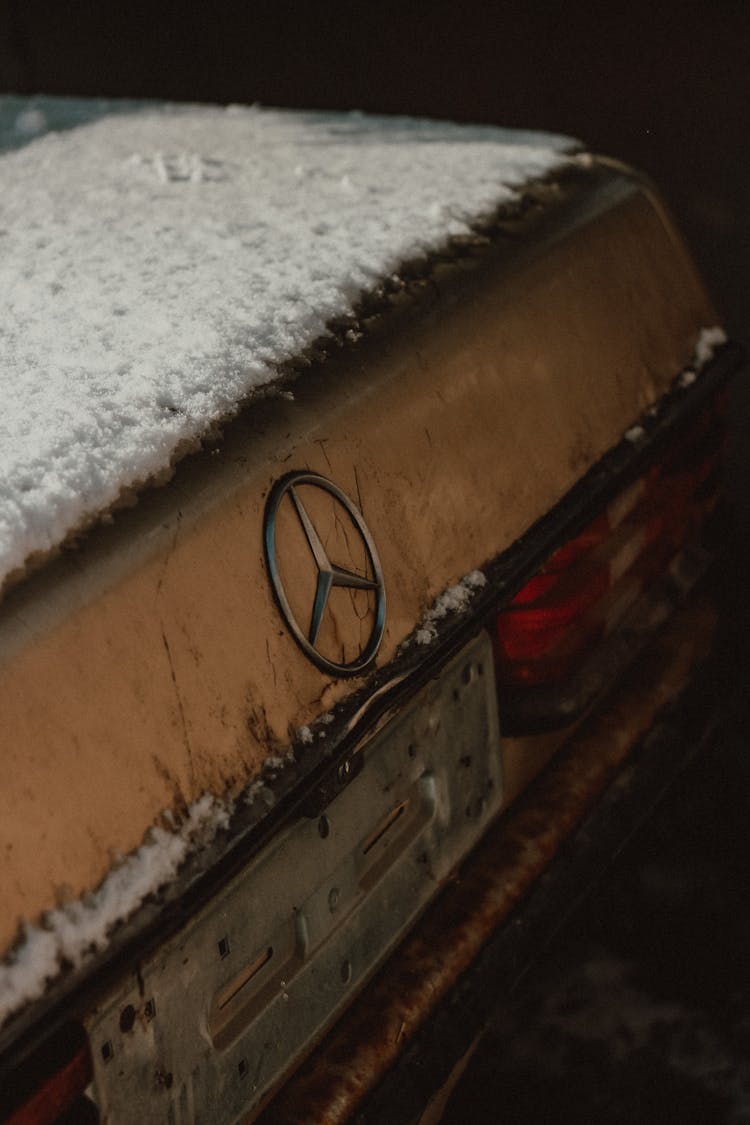 Rusty Car Covered In Snow