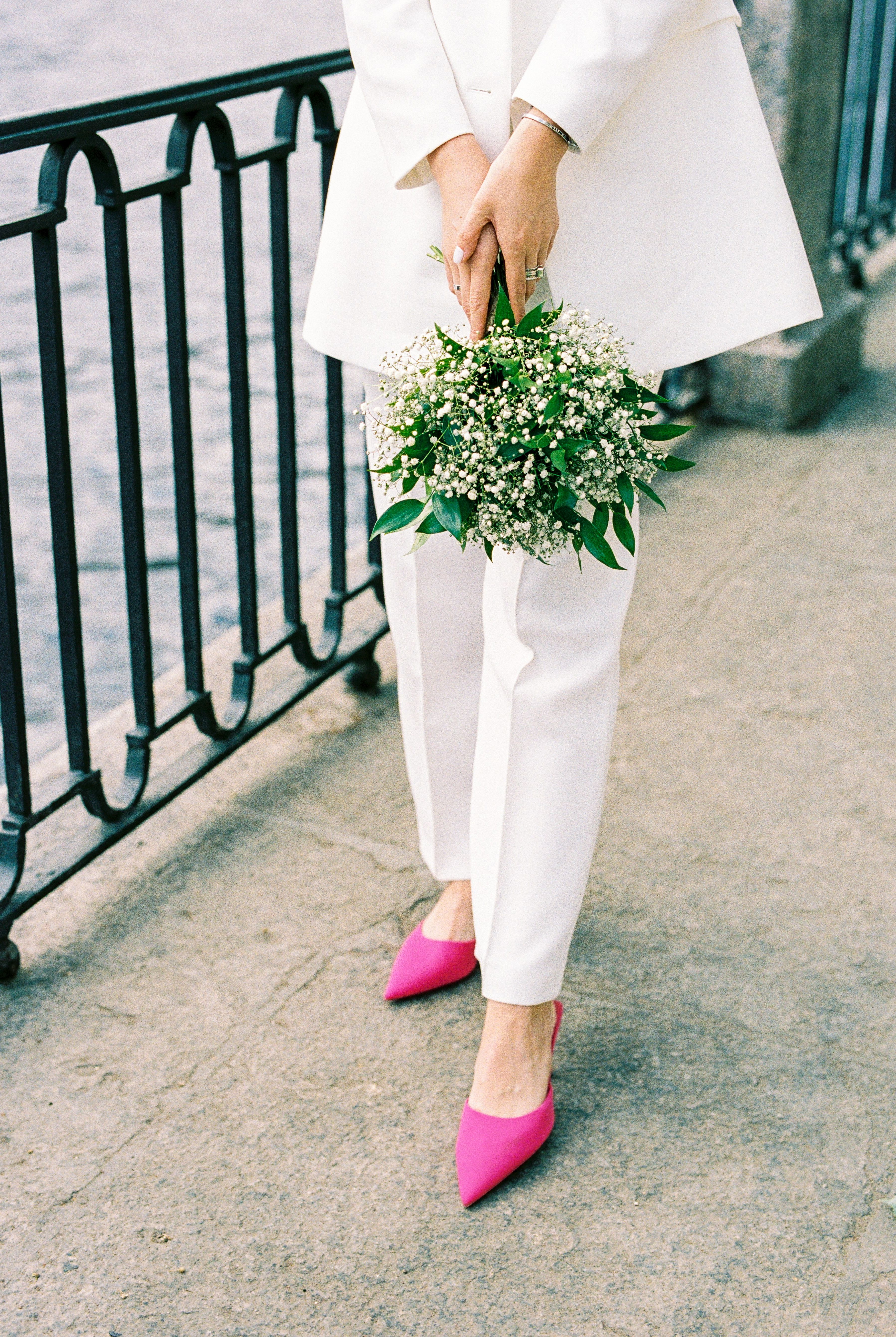 Unrecognizable Woman Wearing White Suit and Pink High Heels Standing on  City Embankment with Bunch of Flowers  Free Stock Photo