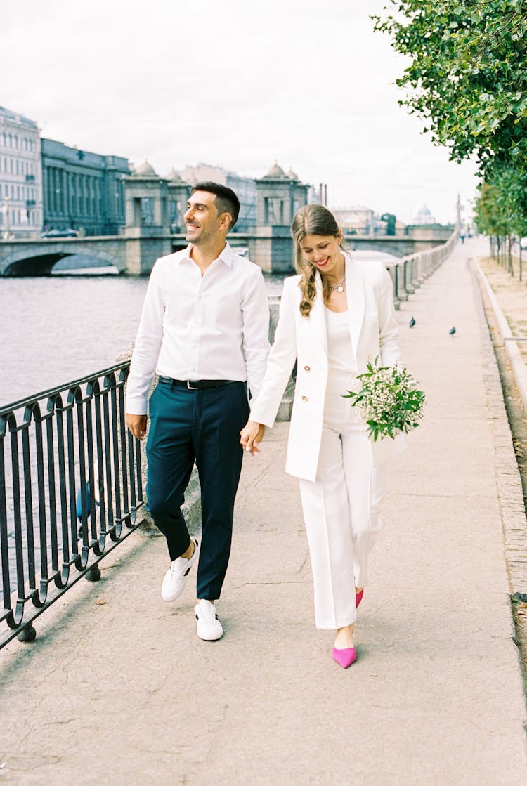 Just Married Couple Walking On Promenade Holding Hands