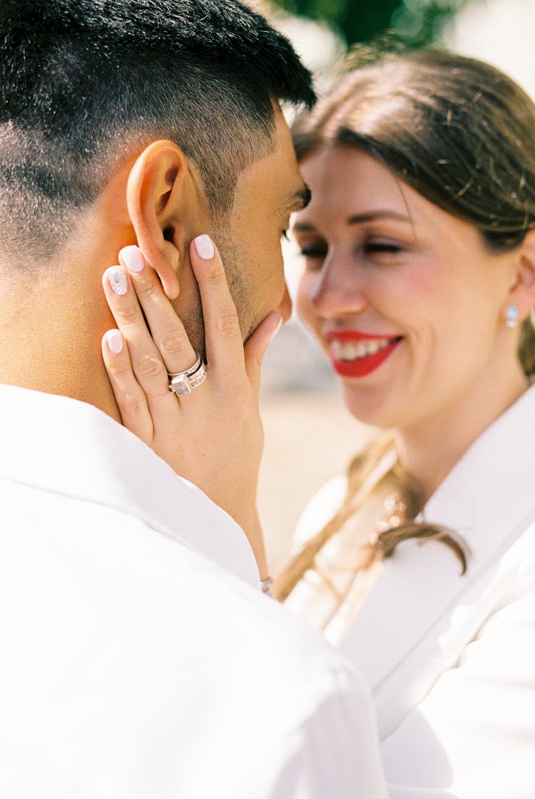 Happy Young Woman Standing Face To Face With Her Man And Touching His Head With Tenderness