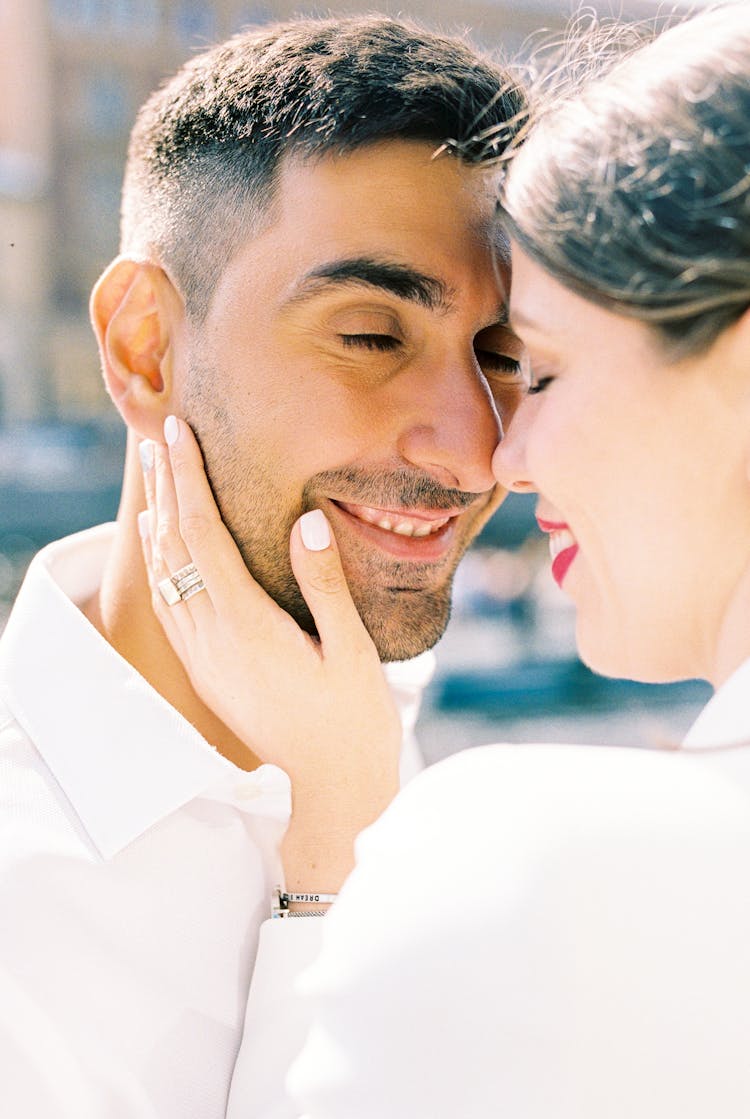 Smiling Pretty Woman Touching Face Of Man With Closed Eyes