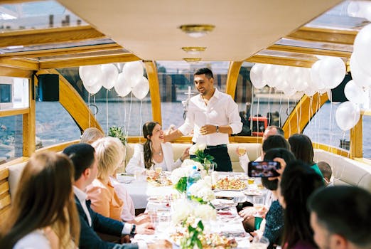 A bride and groom celebrate with guests in a cheerful boat wedding reception.