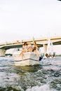 Women Sitting on Flowing Motorboat Bow and Chatting