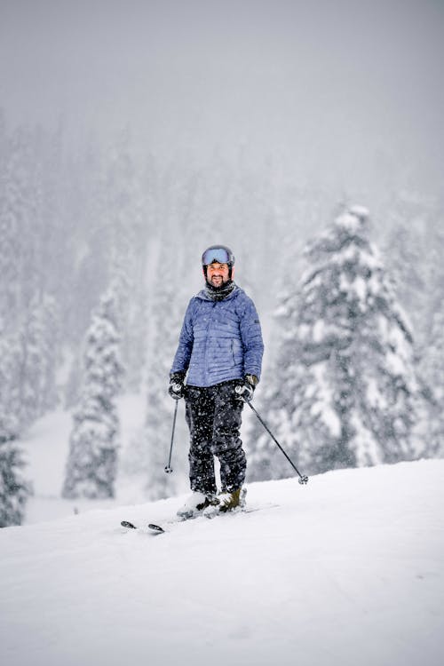 A Man in Skiing on Snow Covered Mountain