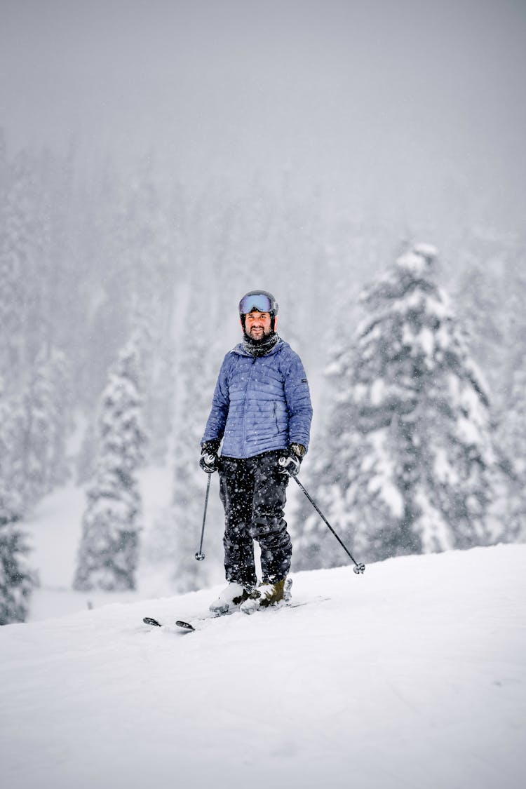 A Man In Skiing On Snow Covered Mountain