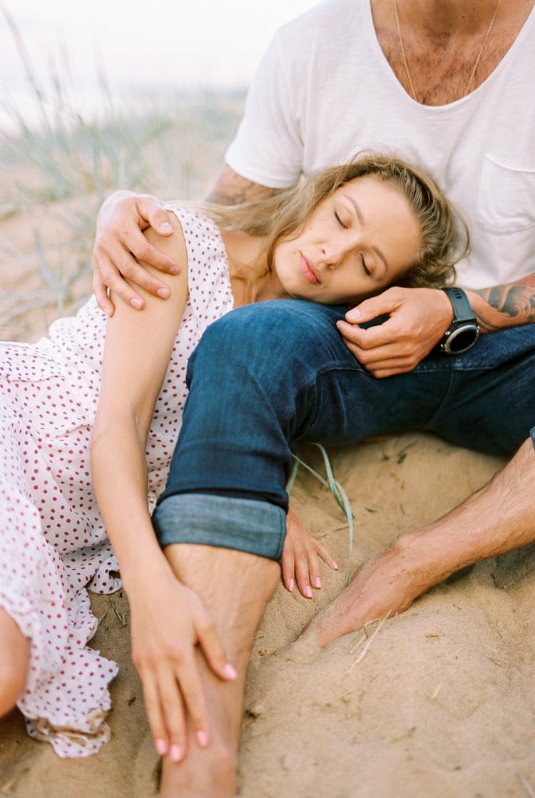 Woman Sleeping On Leg Of Man