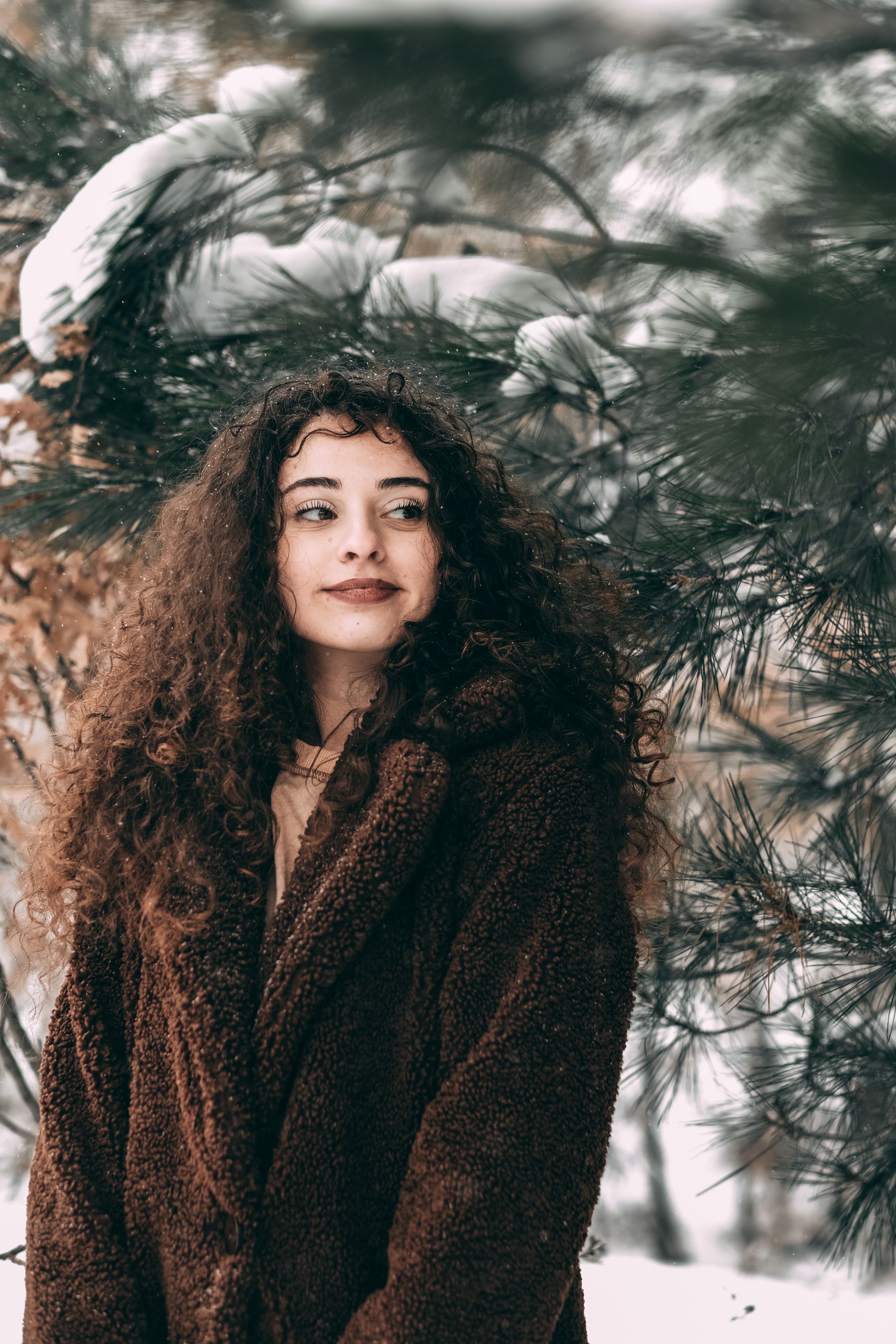 Woman in Brown Coat Standing Beside a Tree · Free Stock Photo