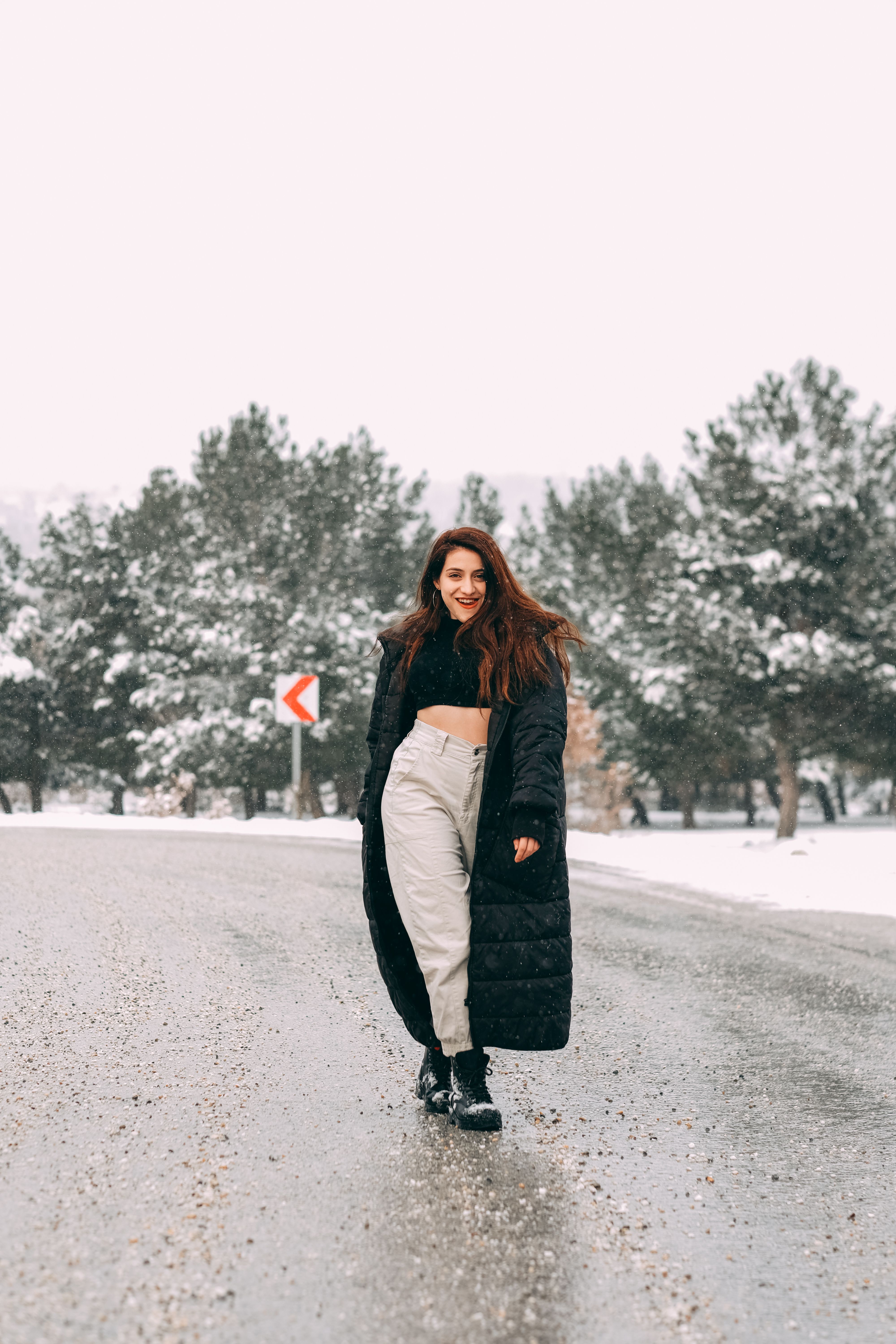 A Woman in Black Coat Walking on the Street · Free Stock Photo