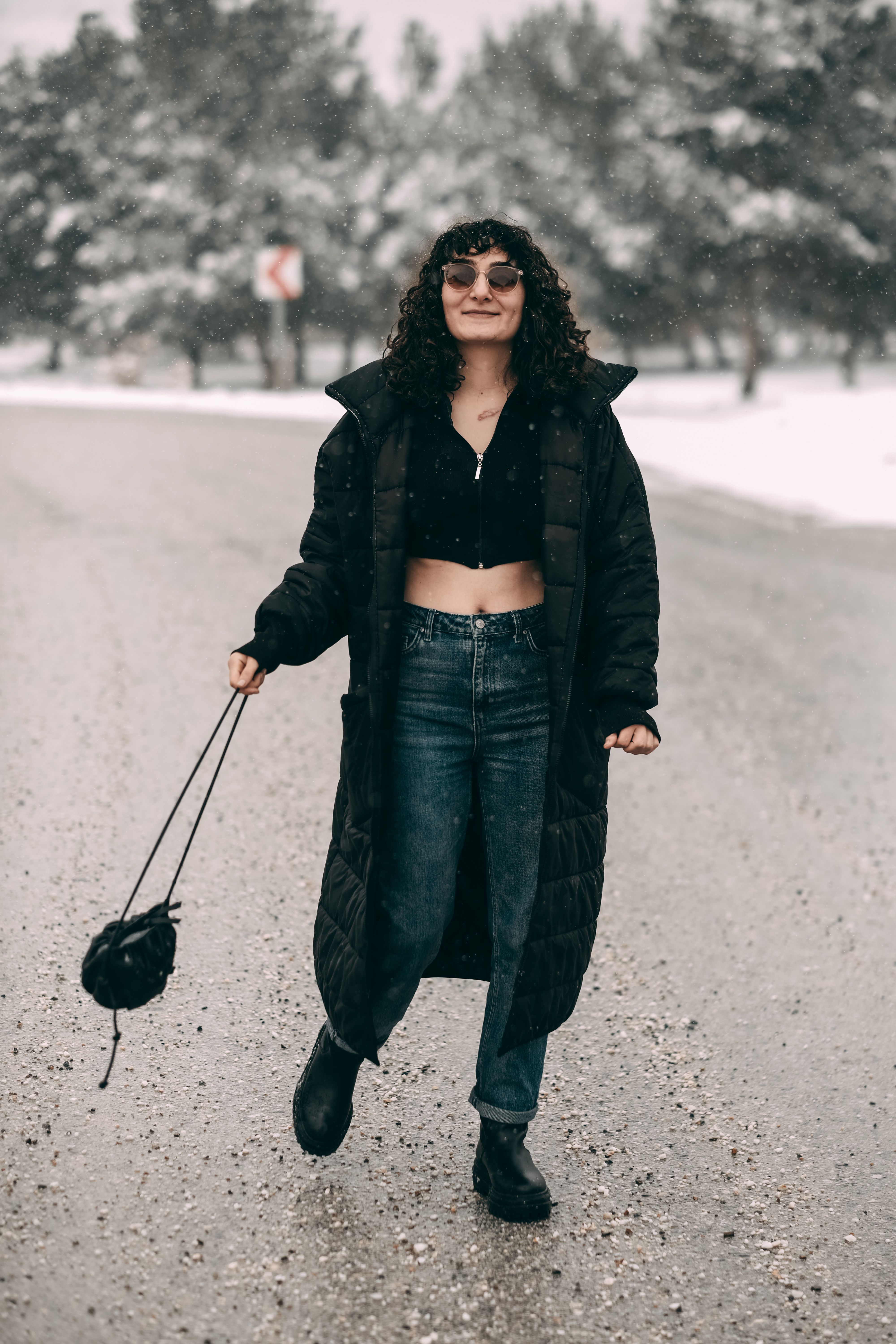 Woman in Black Coat Walking on the Road · Free Stock Photo
