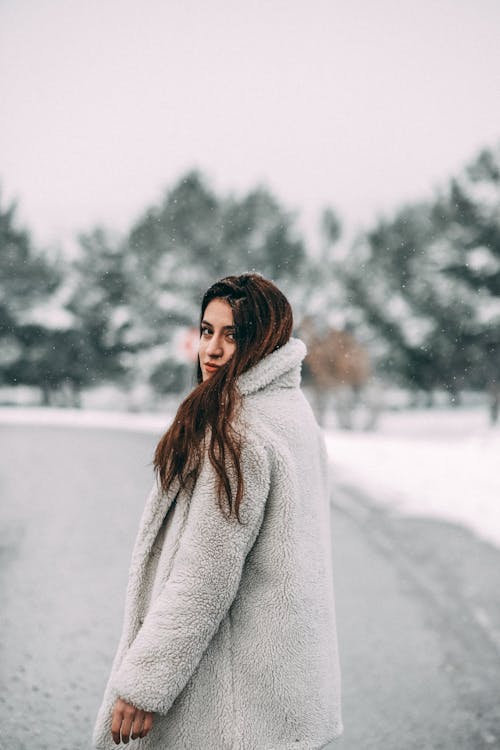 A Woman in Gray Coat Looking at the Camera