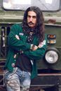 Woman in Green Jacket Standing Beside Green Bus
