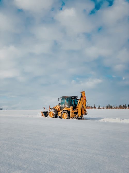 Yellow and Black Heavy Equipment on Snow Covered Ground