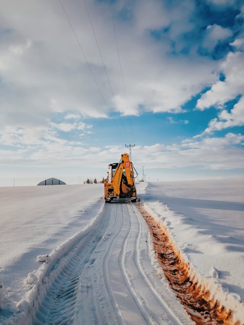 Yellow and Black Heavy Equipment on Snow Covered Field