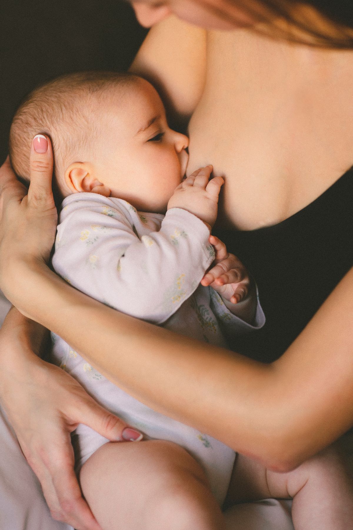 Mother lovingly breastfeeding her baby