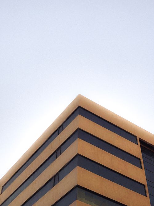 Free Low angle shot of a modern building against a clear sky showcasing urban architecture. Stock Photo