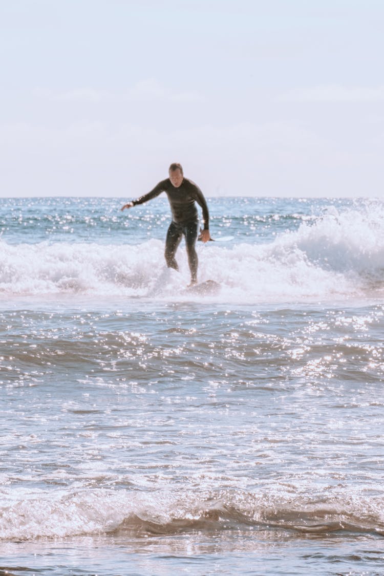 Man Surfing In Ocean