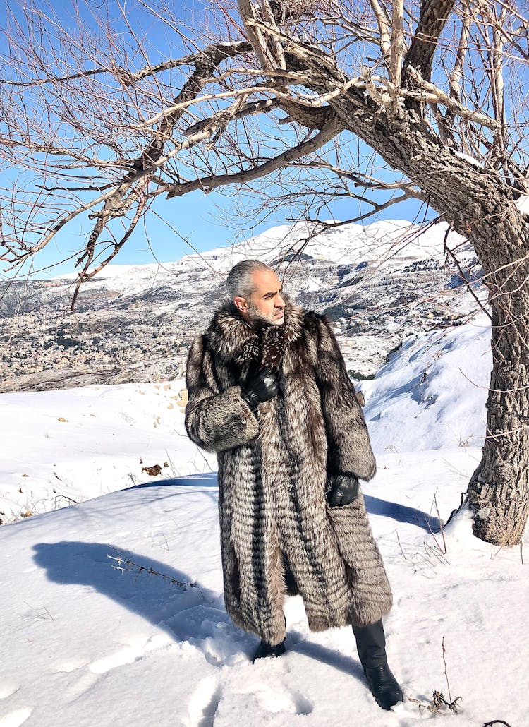 Old Man In Fur Coat In Winter Field