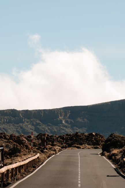 A serene mountain road with a clear sky, perfect for travel and adventure.