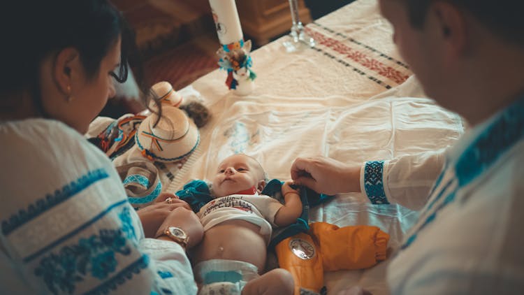 Parents Taking Care Of Baby