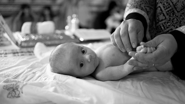 A Newborn Baby Lying Down