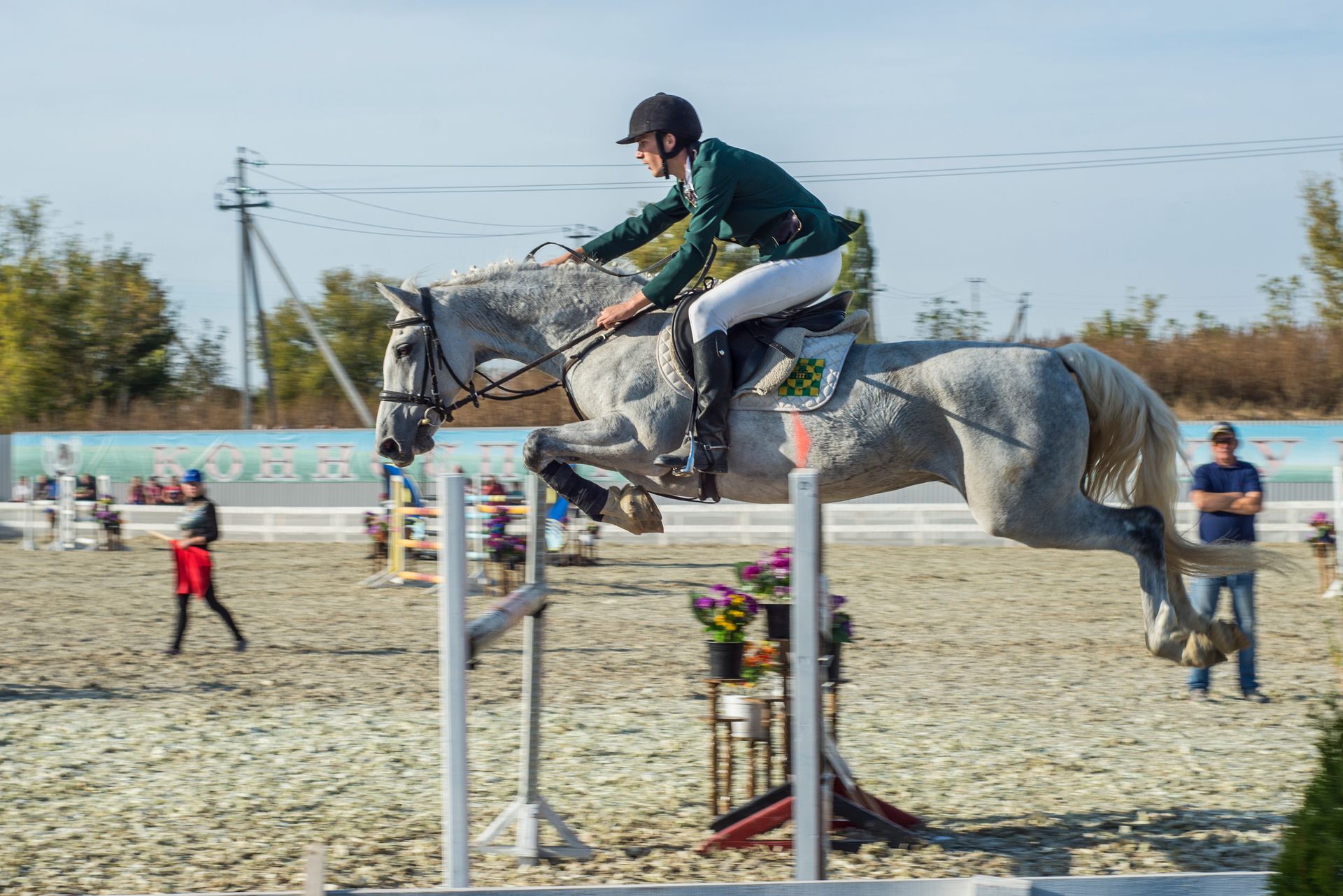 Man on a Horse Jumping Over a Pole