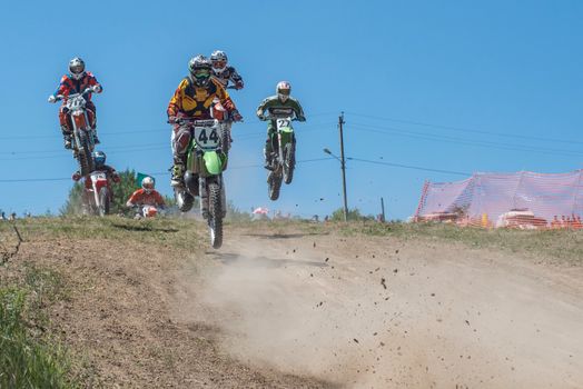 Man in Green and Black Motocross Helmet Riding Green Bicycle