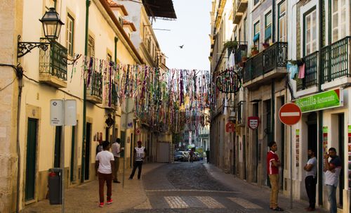 Free Street view with decorative ribbons hanging above, vibrant urban setting. Stock Photo