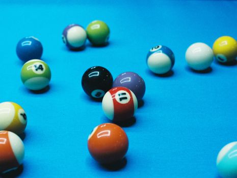 A dynamic close-up shot of colorful billiard balls on a blue pool table, adding vibrancy to any space.