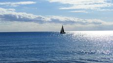 Sailboat on Sea Under White Clouds