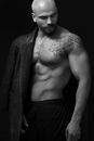Man in Black Pants With Black Tattoo on His Chest
