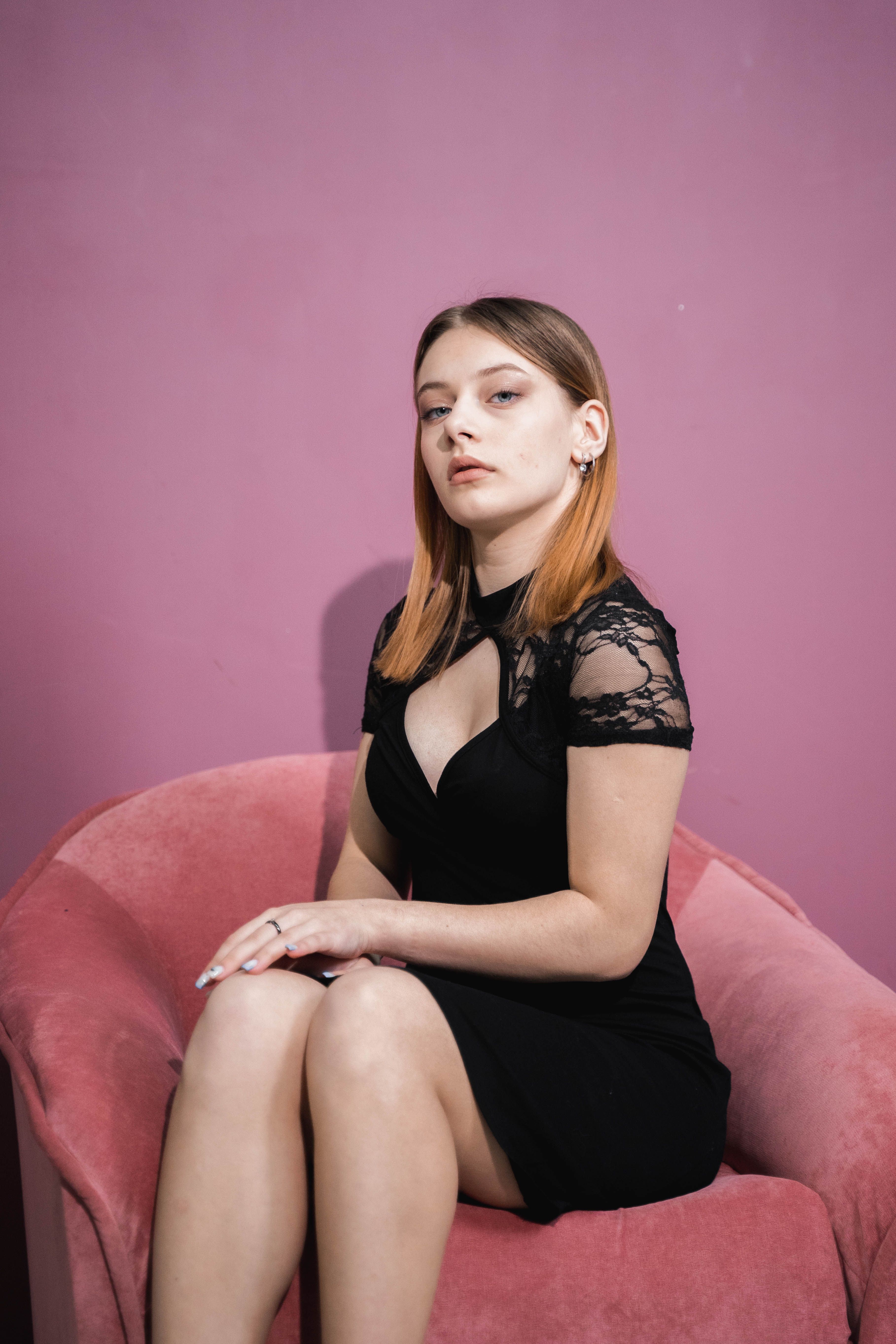 A Woman in a Black Dress Sitting on a Chair · Free Stock Photo
