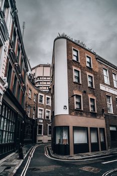 Explore the dramatic architecture and narrow streets of downtown London on a cloudy day.