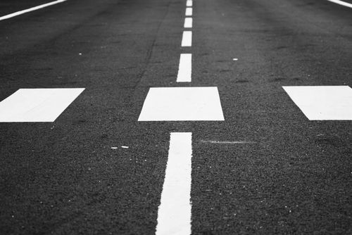 Free Black and white image of a pedestrian crossing and road markings, offering an urban minimalist vibe. Stock Photo