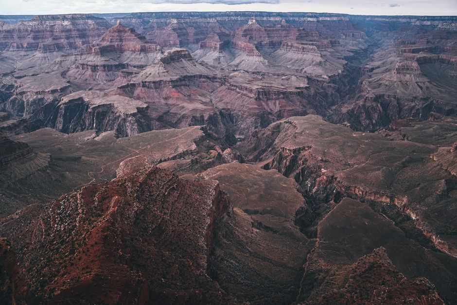 Breathtaking aerial view of the Grand Canyon showcasing its vast geological formations under a clear sky.